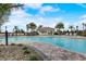 Community pool with chairs and beautiful landscaping at 10258 Morning Mist Ln, Sarasota, FL 34241