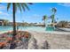 A luxury community pool with water features, landscaping, and plenty of space to soak up the sun at 10258 Morning Mist Ln, Sarasota, FL 34241
