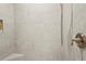 Close-up of a shower with tiled walls, a built-in niche, and bronze fixtures at 10258 Morning Mist Ln, Sarasota, FL 34241