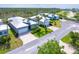 A beautiful aerial view of four homes, landscaping, and neighborhood at 10487 Coquina Ct, Placida, FL 33946