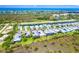 Aerial view of community featuring landscaped homes and the community pool at 10487 Coquina Ct, Placida, FL 33946