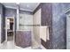 The bathroom offers a walk-in shower with designer tile accents and stylish wallpaper at 10487 Coquina Ct, Placida, FL 33946