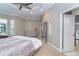 A bedroom featuring a dresser, a large mirror, and a door to the bathroom at 10487 Coquina Ct, Placida, FL 33946