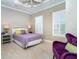 A bedroom featuring a ceiling fan, tile floors, an accent chair, and lots of light at 10487 Coquina Ct, Placida, FL 33946