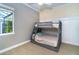 A bedroom featuring a bunk bed and a window allowing plenty of light into the space at 10487 Coquina Ct, Placida, FL 33946