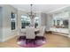 Elegant dining room featuring a round table, stylish chairs, and large windows at 10487 Coquina Ct, Placida, FL 33946