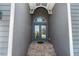 Inviting covered entryway with a beautiful blue double door at 10487 Coquina Ct, Placida, FL 33946