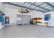 Garage is well equipped with storage cabinets, water heater, golf clubs, and kayaks at 10487 Coquina Ct, Placida, FL 33946