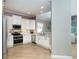 Bright kitchen with stainless steel appliances, white cabinets, and granite countertops at 10487 Coquina Ct, Placida, FL 33946