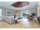 Open living room with decorative ceiling, hardwood floors, and seamless access to outdoor space at 10487 Coquina Ct, Placida, FL 33946