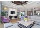 Spacious living room with hardwood floors, decorative ceiling, and cozy seating at 10487 Coquina Ct, Placida, FL 33946