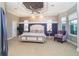 Elegant main bedroom features a tray ceiling, decorative wall trim, and comfortable furnishings at 10487 Coquina Ct, Placida, FL 33946
