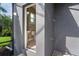 Outdoor shower with gray walls, brick flooring and easy access to the interior half-bath at 10487 Coquina Ct, Placida, FL 33946