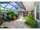 Inviting outdoor patio with a seating area and lush tropical plants at 10487 Coquina Ct, Placida, FL 33946