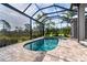 Inviting backyard pool and spa area enclosed by a screen offering privacy and a beautiful landscape view at 10487 Coquina Ct, Placida, FL 33946
