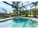 Sparkling pool and spa enclosed by a screen, surrounded by a tiled patio, plants and lush landscaping at 10487 Coquina Ct, Placida, FL 33946