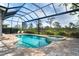 Backyard featuring a screened-in pool and spa, surrounded by a brick patio and scenic backyard views at 10487 Coquina Ct, Placida, FL 33946
