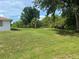 Spacious backyard featuring lush lawn and surrounding trees; great for outdoor activities at 11029 Vanessa Ave, Englewood, FL 34224