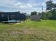 Expansive backyard featuring a screened pool area and storage shed at 11029 Vanessa Ave, Englewood, FL 34224