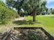 Backyard features a palm tree, empty garden, and plenty of space at 11029 Vanessa Ave, Englewood, FL 34224