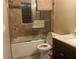 Bathroom featuring a tiled shower-tub with glass doors, a toilet, and a vanity with a light pink countertop at 11029 Vanessa Ave, Englewood, FL 34224
