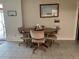 Bright dining space with neutral walls, wood table, and tile flooring at 11029 Vanessa Ave, Englewood, FL 34224