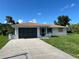 Charming single-story home featuring a well-maintained lawn and a convenient attached garage at 11029 Vanessa Ave, Englewood, FL 34224