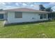 Exterior of home features white paint, brown roof, manicured lawn and enclosed pool at 11029 Vanessa Ave, Englewood, FL 34224