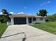 Exterior of home with well-maintained lawn and concrete driveway at 11029 Vanessa Ave, Englewood, FL 34224