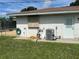 Exterior shows AC, hose, and hurricane shutter in well maintained backyard at 11029 Vanessa Ave, Englewood, FL 34224