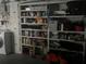 Garage interior featuring shelving loaded with household products and supplies at 11029 Vanessa Ave, Englewood, FL 34224