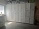 Spacious garage featuring ample white storage cabinets along an entire wall at 11029 Vanessa Ave, Englewood, FL 34224