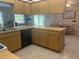 Well appointed kitchen with wooden cabinets and tile floors at 11029 Vanessa Ave, Englewood, FL 34224