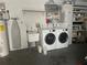 Convenient laundry area features modern washer, dryer, sink, and ample storage for supplies at 11029 Vanessa Ave, Englewood, FL 34224