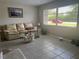 Comfortable living room with tile flooring and plentiful light from window at 11029 Vanessa Ave, Englewood, FL 34224