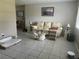 Cozy living room with neutral walls, tile floor, and comfortable seating at 11029 Vanessa Ave, Englewood, FL 34224