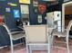 Enclosed patio features a dinette set, mini fridge, and fun sports themed decor at 11029 Vanessa Ave, Englewood, FL 34224