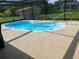 Screened in Kidney shaped pool is ready for a refreshing summer swim at 11029 Vanessa Ave, Englewood, FL 34224