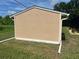 Rear view of shed with white gutters and painted siding on a bright, sunny day at 11029 Vanessa Ave, Englewood, FL 34224