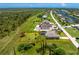 Aerial view showcasing the property's generous lot, mature trees, and screened-in pool at 1119 Boundary Blvd, Rotonda West, FL 33947