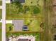 Bird's-eye view of the home showing the pool, backyard, lush landscaping, and location at 1119 Boundary Blvd, Rotonda West, FL 33947