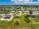 Aerial view displays the property's spacious backyard, screened pool, and mature trees at 1119 Boundary Blvd, Rotonda West, FL 33947