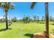 Expansive backyard featuring well-maintained lawn and trees, offering plenty of space for outdoor activities and enjoyment at 1119 Boundary Blvd, Rotonda West, FL 33947