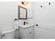 Well lit bathroom features a white vanity with a marble top, a modern mirror and fixtures at 1119 Boundary Blvd, Rotonda West, FL 33947