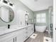 Elegant bathroom with double vanity, soaking tub, and glass enclosed shower at 1119 Boundary Blvd, Rotonda West, FL 33947