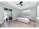 This bedroom features a king sized bed, a ceiling fan, and a sliding door to the outside at 1119 Boundary Blvd, Rotonda West, FL 33947