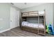 Cozy bedroom with a wooden bunk bed, hardwood floors, and a white closet door at 1119 Boundary Blvd, Rotonda West, FL 33947
