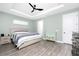 This bedroom features a king sized bed, a ceiling fan, hardwood floors and light green walls at 1119 Boundary Blvd, Rotonda West, FL 33947