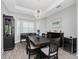 Elegant dining room with modern lighting, wood-look floors, and ample natural light at 1119 Boundary Blvd, Rotonda West, FL 33947