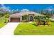Beautiful single-story home featuring a manicured lawn and a large, attached two-car garage at 1119 Boundary Blvd, Rotonda West, FL 33947